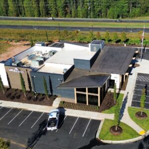 Aerial view of a commercial building that had commercial roofing services with parking lot in Gainesville, GA